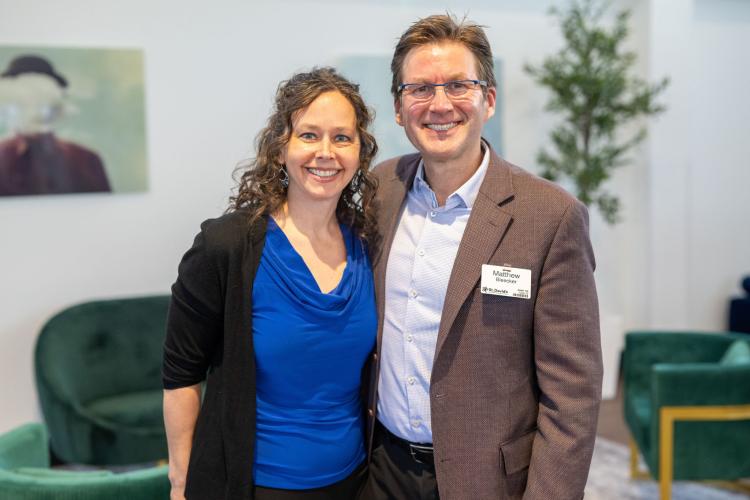 Man and woman in lobby of gala event.