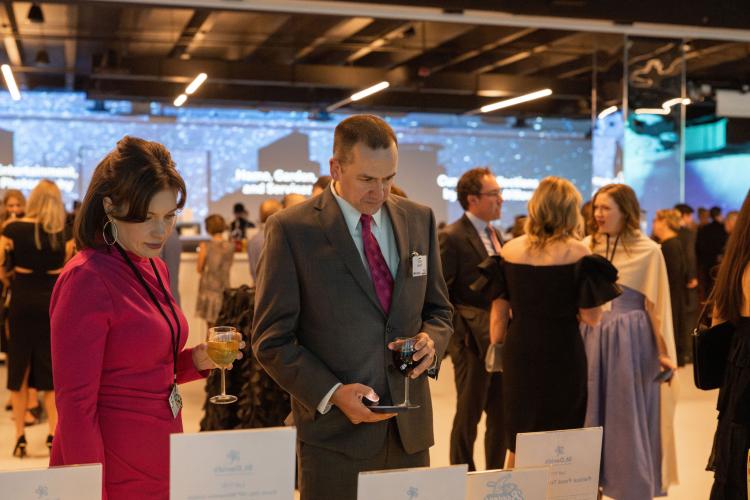 People check out silent auction tables at gala. 
