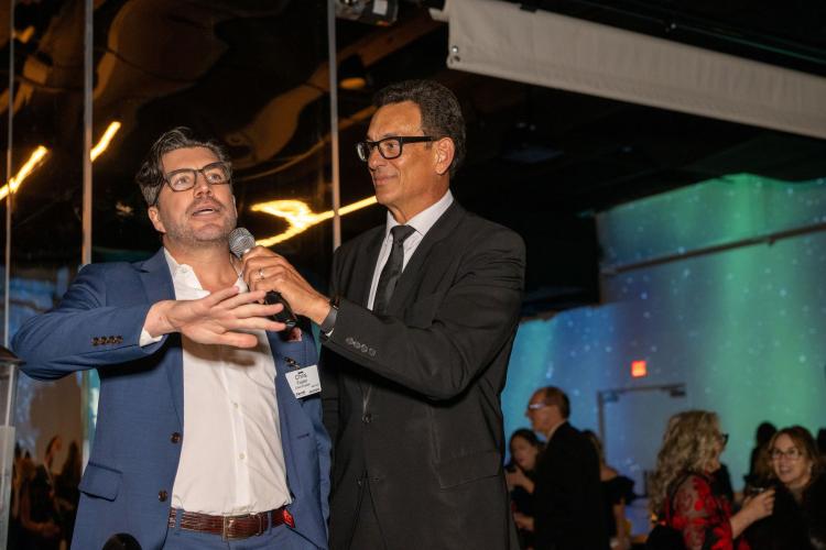 Chris Foster and Frank Vascellaro holding a mini auction prior to dinner. 