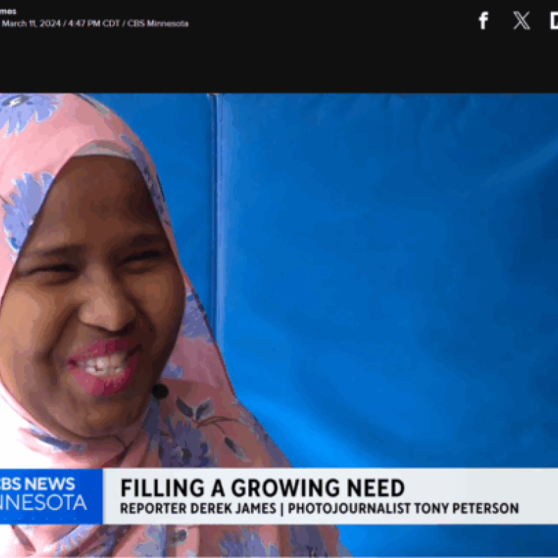 An image still of a news broadcast with a woman smiling