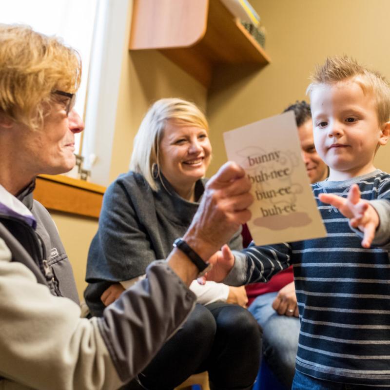 People handing a child paper