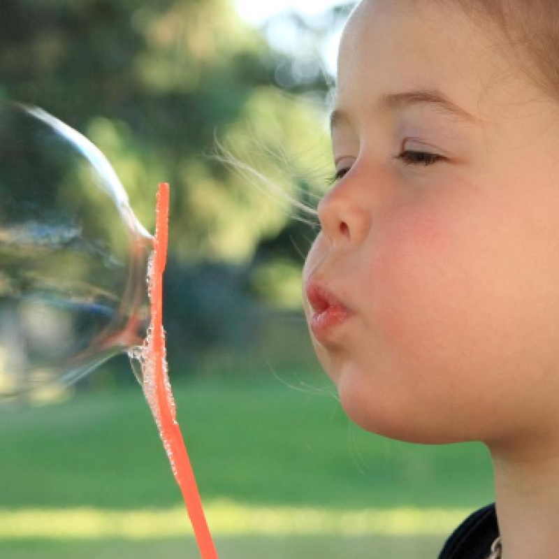 A child blowing a soap bubble