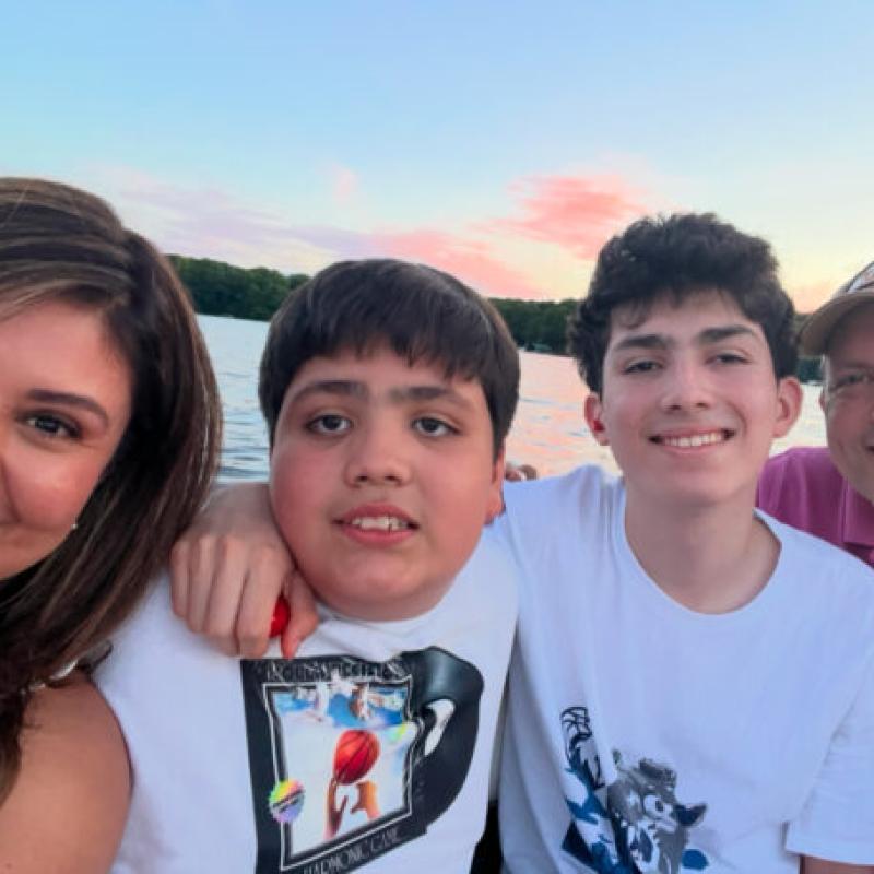 A family on a boat smiling at the camera