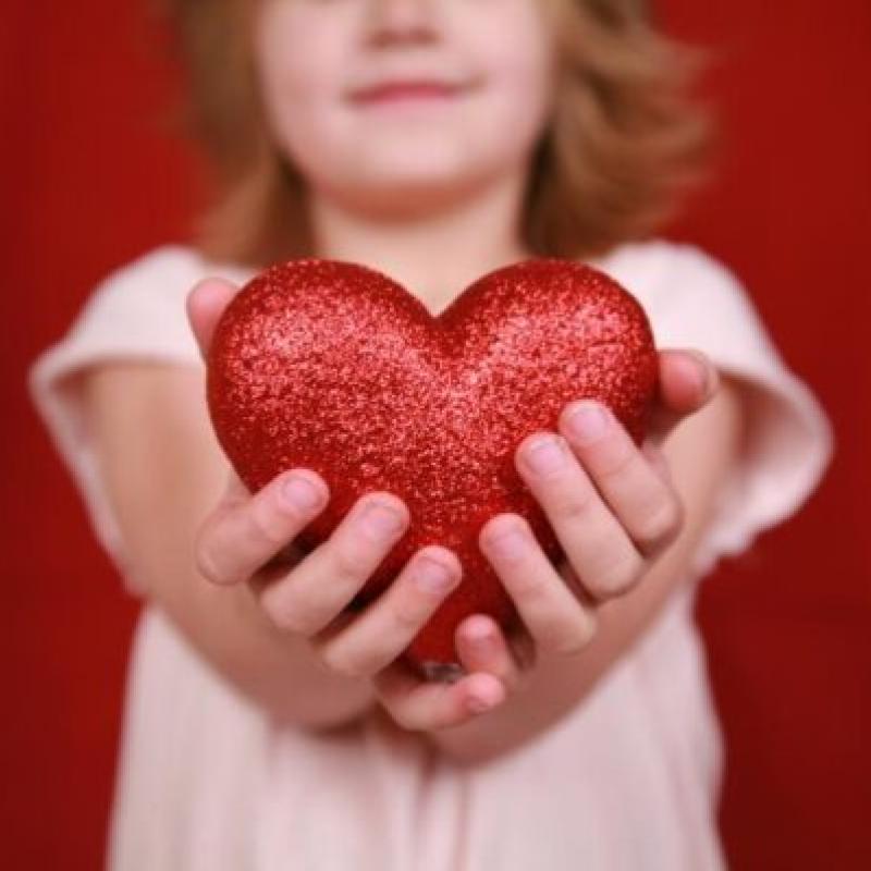 A child holding a heart shaped object