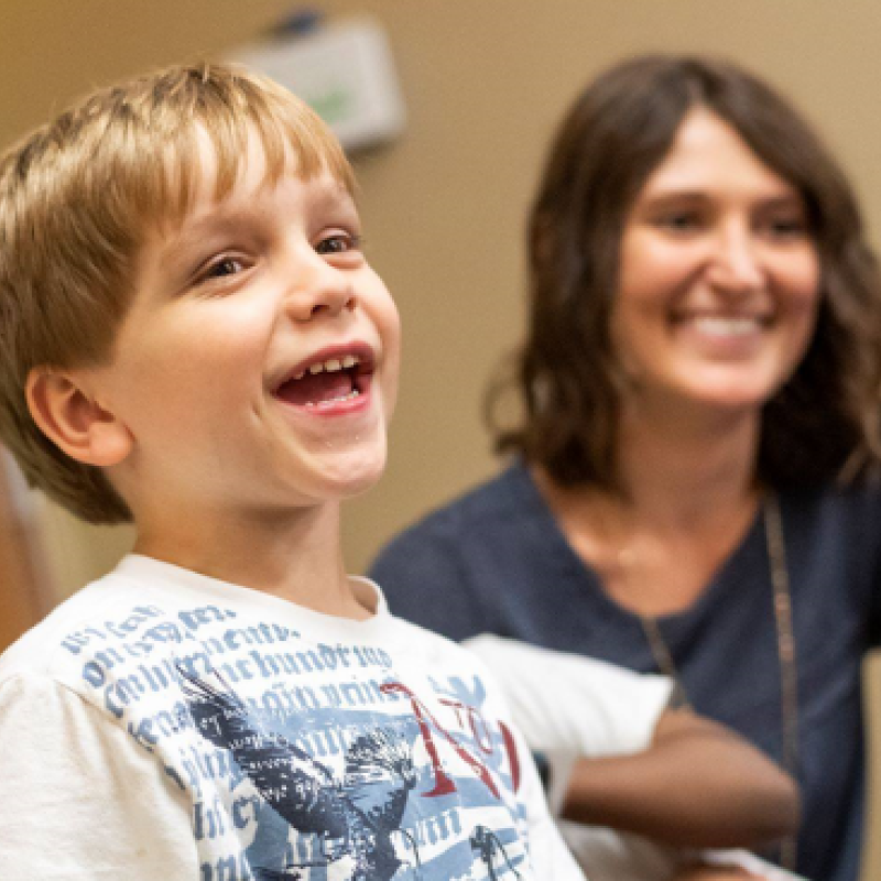 A child and mother smiling