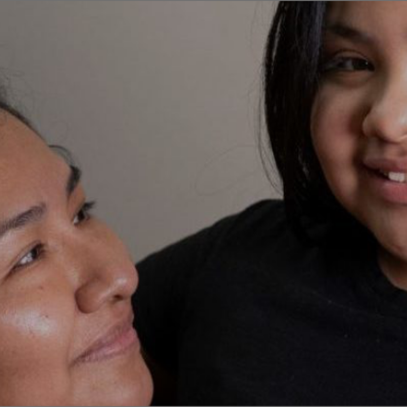 A child and parent smiling