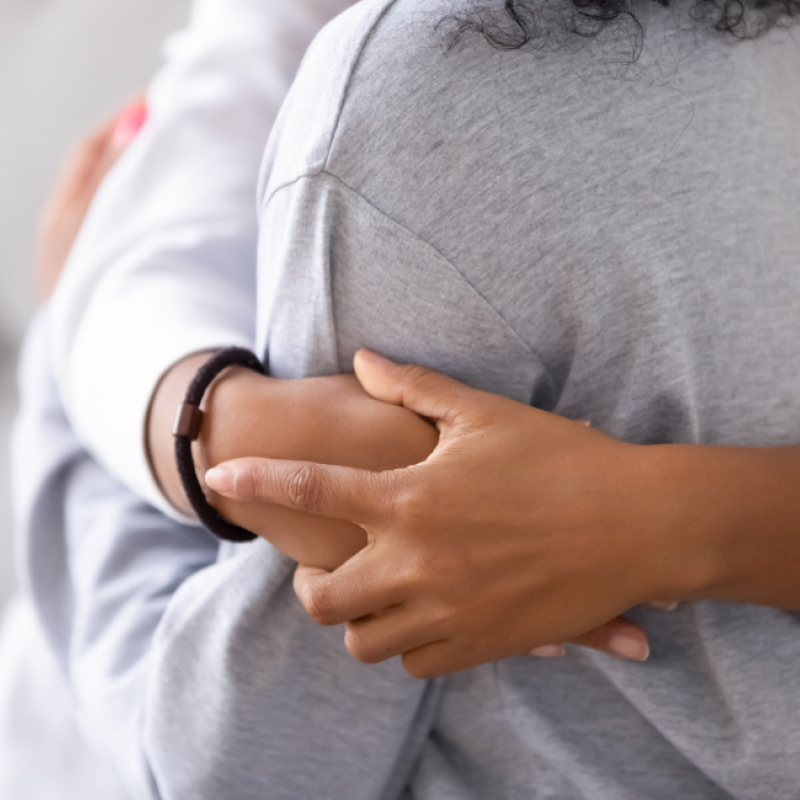 A close up of two people hugging