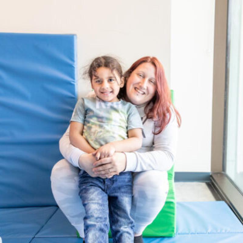 A woman hugging a smiling child