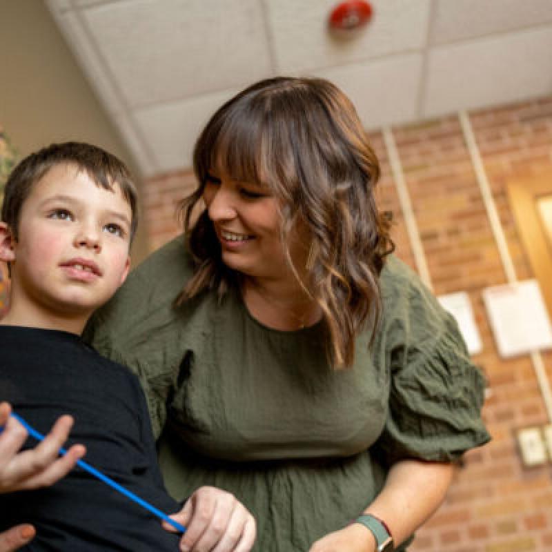 A woman helping a child
