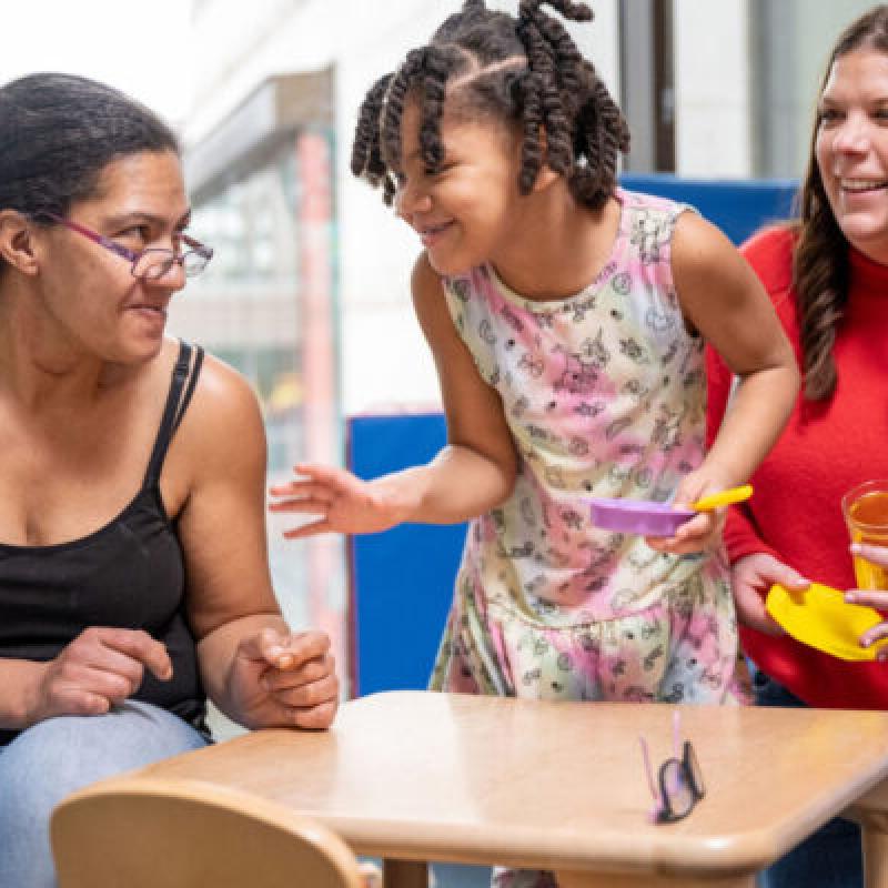 Two adults and a smiling child