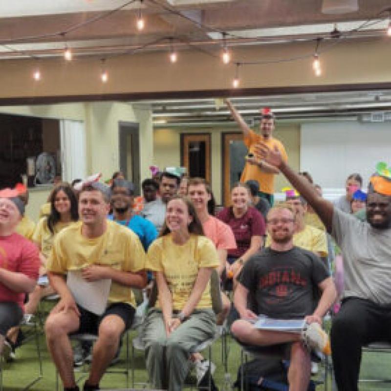 A group of smiling people in a conference room