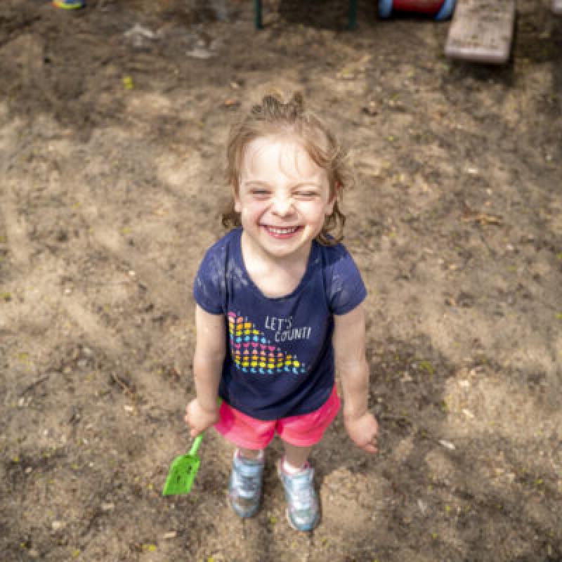 A child smiling in the sun