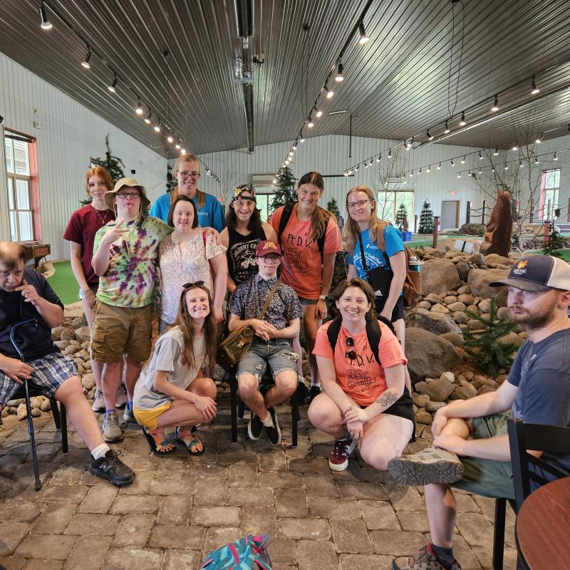 Group of adults with needs on a field trip with staff. 