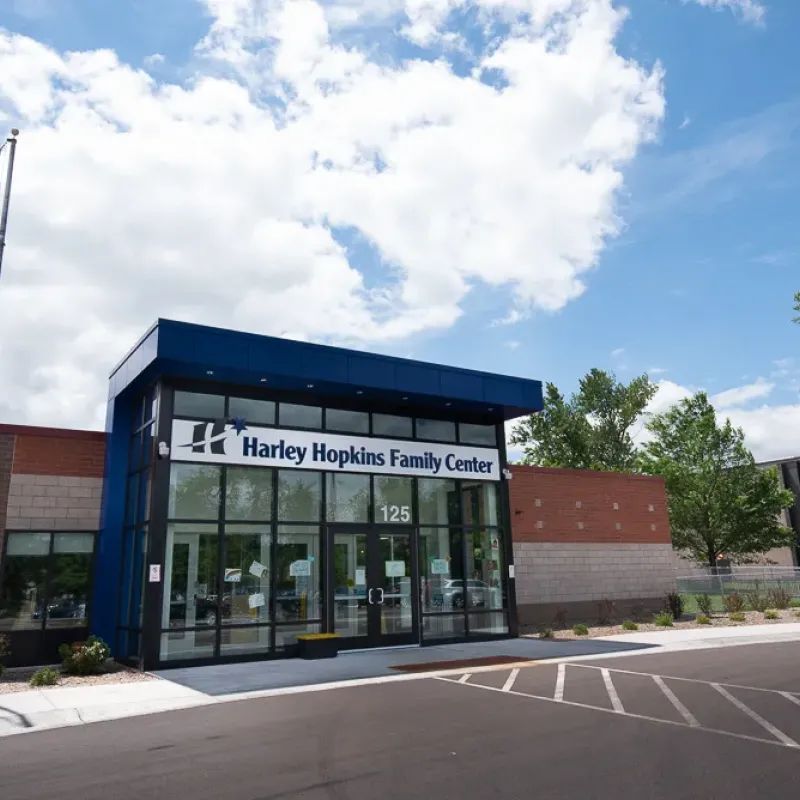 Image of a building with an American flag out front and a sign that says Harley Hopkins Family Center.
