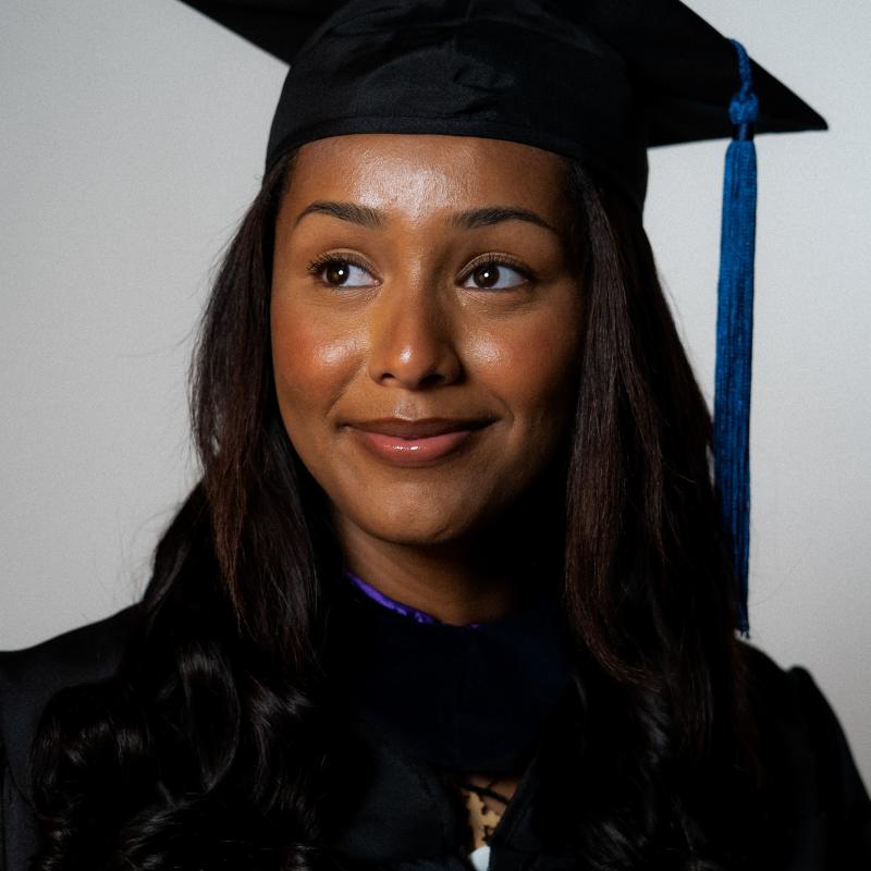 new grad bemnet habtamu smiles for the camera in her graduation gown